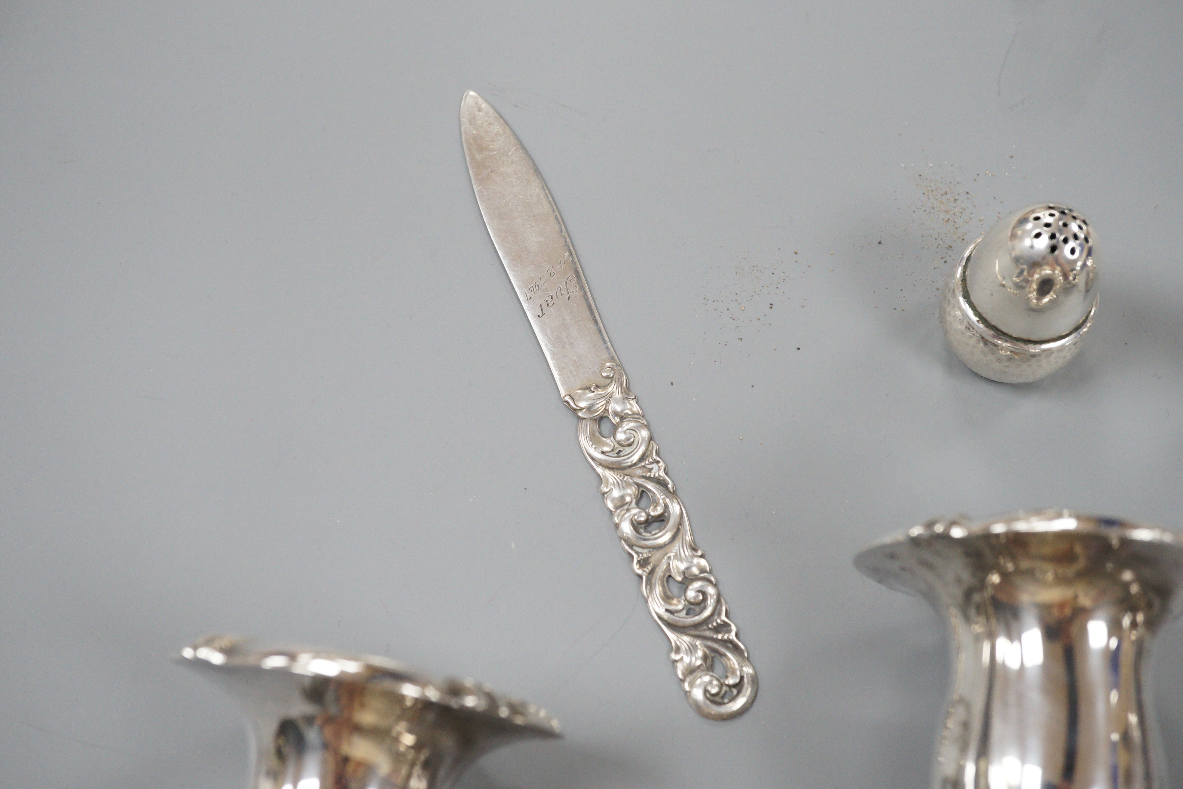 A 20th century Danish 830 standard white metal candelabrum, height 25.6cm, weighted, a pair of Danish white metal acorn condiments and a Danish white metal paper knife.